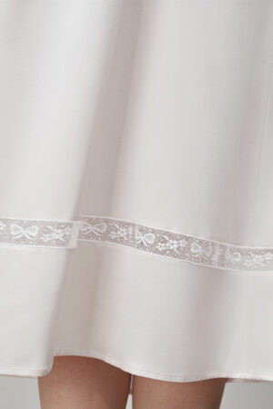 Hem detail of MANITO Duchess Tank Silk Maxi Dress showing hollow bow-pattern lace.