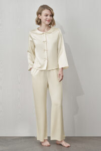 MANITO Duchess Women's Silk Pajama Set in cream with bow buttons and doll collar, full-body front view.