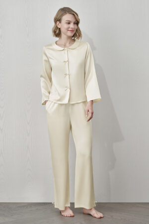 MANITO Duchess Women's Silk Pajama Set in cream with bow buttons and doll collar, full-body front view.