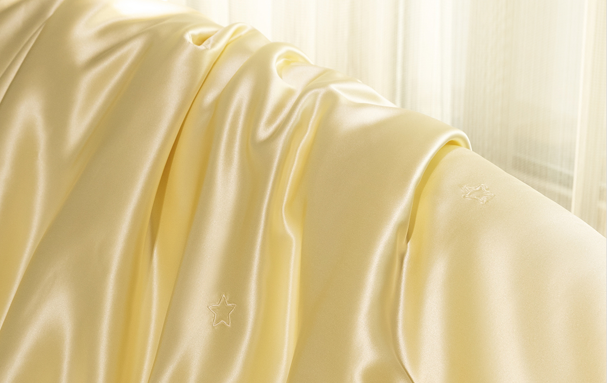 Luxurious golden silk fabric with intricate star embroidery, perfect for sophisticated home decor by MANITO Silk