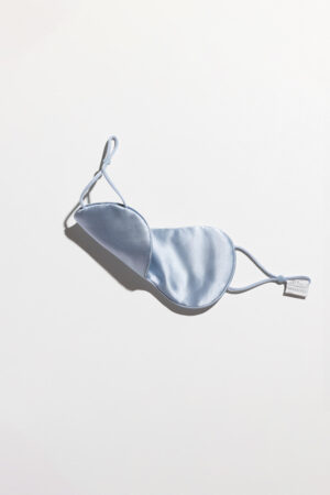 Side view of blue Cozy Silk Eye Mask showing curved contour and Soft Light® silk sheen.