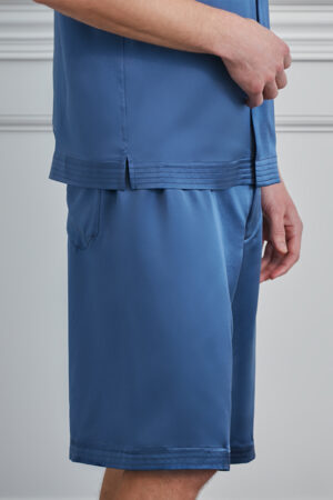 Close-up of hem and shorts pocket detail on blue MANITO Sketchy Pajama Set.