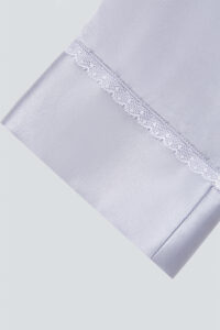 Close-up of the sleeve with white lace detail from the MANITO Effie Women's Pajama Set.