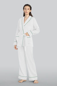 A woman wearing MANITO Embossed striped pajama set in white, standing barefoot.
