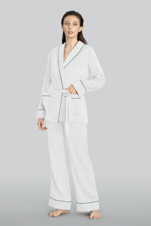 A woman wearing MANITO Embossed striped pajama set in white, standing barefoot.