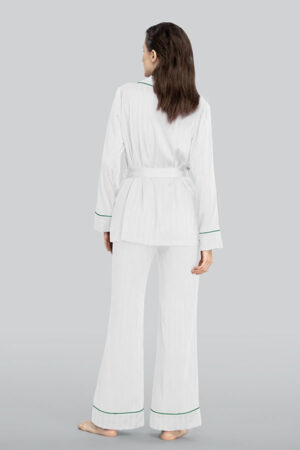 A woman seen from the back, wearing MANITO Embossed striped pajama set in white.