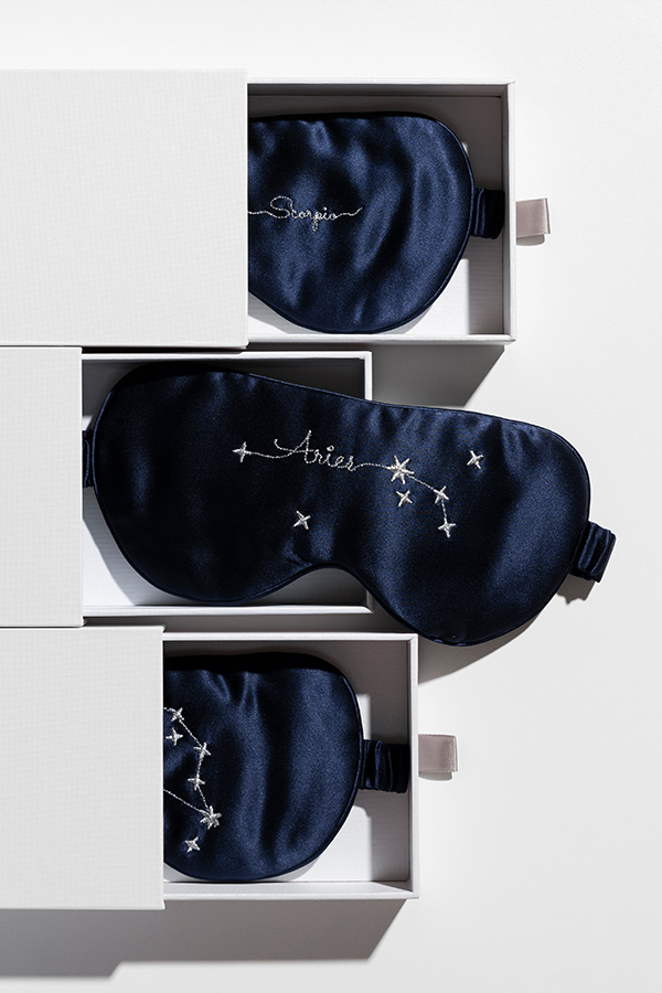 Stellar Zodiac Silk Eye Mask in gift box, featuring navy silk fabric and silver constellation embroidery.