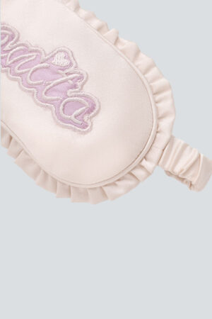 Close-up of Fairy Kid's Eye Mask showing MANITO logo embroidery and ruffled silk edge.