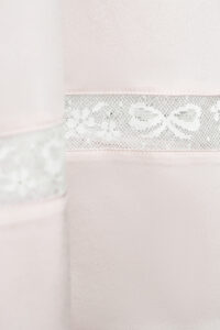 Hemline lace detail of MANITO Fairy Kid's Tank Nightdress featuring delicate bow motifs.