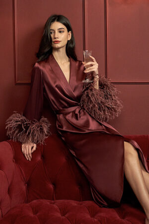 Red long robe crafted from 22 momme charmeuse silk with graceful feather details, perfect for festive occasions.