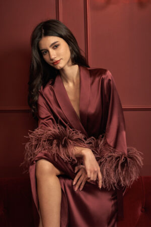 Elegant red charmeuse silk long robe featuring hand-stitched Italian feathers and a belt, ideal for holiday gatherings.