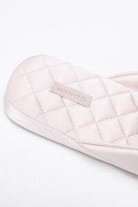 Close-up of MANITO Silk Women's pink slipper's textured sole, showcasing detailed craftsmanship.