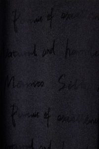 Close-up of the fine velvet detailing on Fiesta long black robe with feathers for holiday.