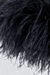 Detailed feather design on the cuff of Fiesta velvet holiday pajama set in black.