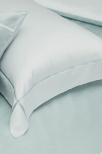 Close-up of the mint green MANITO Fluora Silk Pillowcase, featuring clean stitching and soft, luxurious mulberry silk texture.