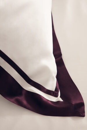 Detailed close-up of French Trim Silk Bed Duvet Cover's corner, highlighting its refined stitching.