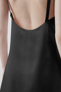 Close-up view of the back of black Glitter short dress, with a focus on the stylish straps.