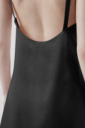 Close-up view of the back of black Glitter short dress, with a focus on the stylish straps.