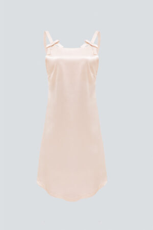 Full view of a short pink Glitter dress, showcasing a flowy design and unique bow details.