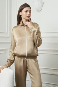 Woman wearing Gloaming Women's Pajama Set, showing the soft stretch silk fabric and subtle piping details.