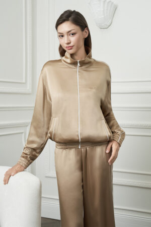 Front view of woman in Gloaming Women's Pajama Set, emphasizing the sleek zip-front silk jacket and relaxed waistband.