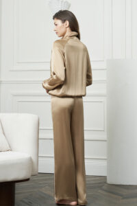 Back view of woman in Gloaming Women's Pajama Set, displaying the smooth drape of the stretch silk jacket and pants.