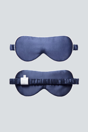 Sleek MANITO HA Silk Eye Mask in navy shown from both sides, offering a soft touch and gentle fit for restful nights.