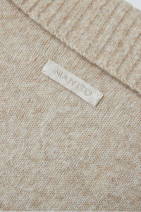 Heather Women's Silk Cashmere Knit Pullover back label detail showing the MANITO logo on soft wool blend.