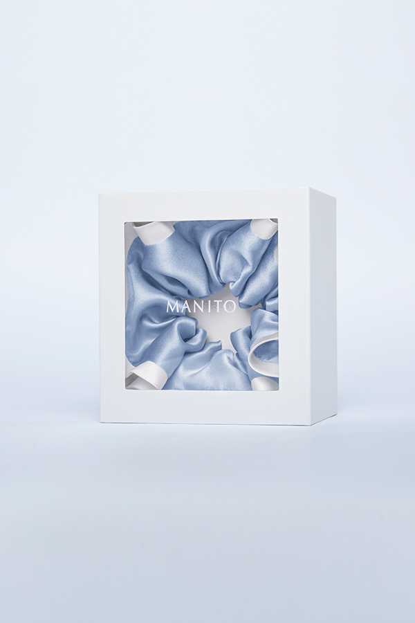 Two-tone Silk Scrunchie in classic peony white creates a sweet vintage look, beautifully displayed in a gift box at the center.
