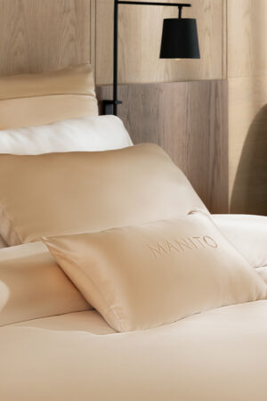 Elegant silk bedding arrangement featuring MANITO Infinity Mulberry Silk Pillowcase and duvet cover.