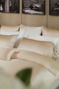 Beautifully layered MANITO silk bedding set in a stylish bedroom, featuring Infinity Mulberry Silk Duvet Cover.