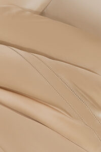 Detailed close-up of MANITO Infinity Silk Duvet Cover's intricate stitching.