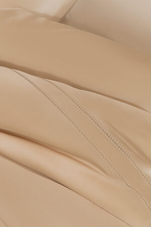 Detailed close-up of MANITO Infinity Silk Duvet Cover's intricate stitching.