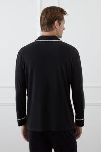 Back view of a man wearing the black MANITO Jersey Men's Modal Silk Pajama Set.