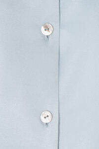 MANITO Jolly Women's Silk Pajamas Set close-up of pearl button with engraved logo.