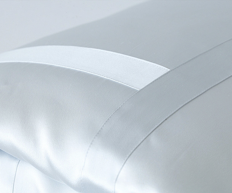 Sumptuous Soft Light silk bedding, featuring a lustrous finish with an elegant sheen and delicate stitching detail, exemplifying MANITO's commitment to luxury and quality craftsmanship.