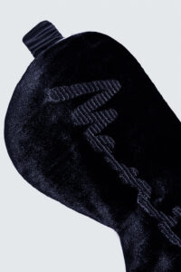 Close-up of Ladylike Silk Velvet Blue Eye Mask showing the elegant "MANITO" embroidered detail on soft velvet fabric.