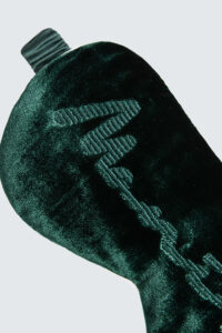 Close-up of green velvet Ladylike Silk Velvet Eye Mask showing detailed embroidery and soft fabric texture.