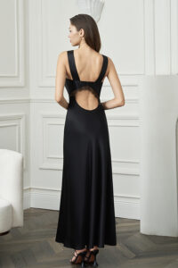 Back view of woman in Latica Lace Maxi Dress, revealing the lace-trimmed cut-out and softly flared skirt.