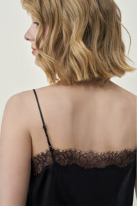Back view of MANITO Latica Lace Silk Camisole Top in black worn by model, showing lace and straps.