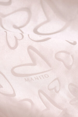 Close-up of MANITO logo and heart jacquard fabric on the Loving Kid's Nightdress.