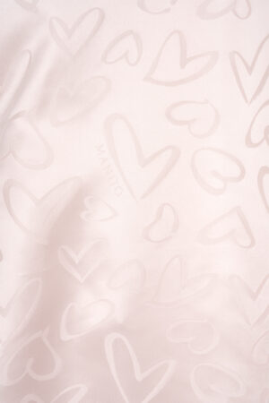 Details of MANITO Loving Silk Nightdress with tonal heart motifs and faint logo, showcasing texture and softness.