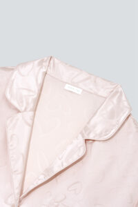 Close-up of the collar on MANITO Loving Women's Pajama Set, showcasing smooth silk texture and subtle jacquard hearts.