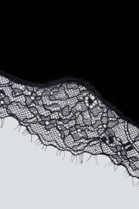 Detailed shot of MANITO Luella Silk Velvet Black Nightdress's hemline, highlighting the fine craftsmanship and luxurious fabric.