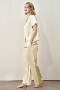 Side view of MANITO Lunavie Women's Silk Short Sleeve Pajama Set in pear sorbet color, showing soft silk fabric and relaxed fit.