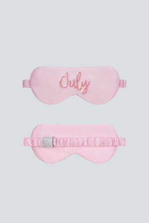 Pink Lune Silk Eye Mask featuring “July” sequin embroidery and smooth silk texture.