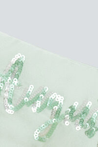 Close-up of “August” sequin embroidery detail on the mint green Lune Silk Eye Mask.