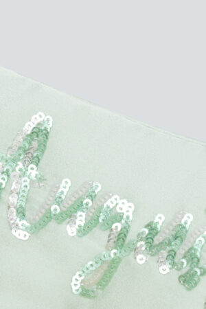 Close-up of “August” sequin embroidery detail on the mint green Lune Silk Eye Mask.