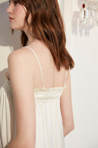 Close-up of ruffle detail and spaghetti straps on Blooming Women's Silk Midi Slip Dress.