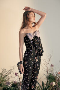 Woman in Lrisette Bow Camisole and Silk Pants Set.